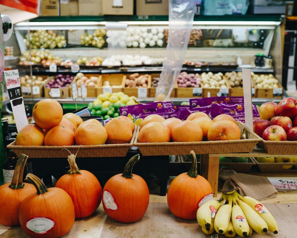 Colorful produce display at a Toronto market featuring pumpkins, apples, and citrus fruits.